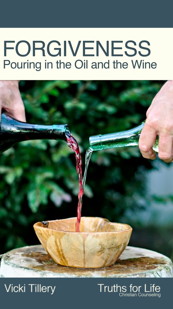 A person pouring wine into a cup.